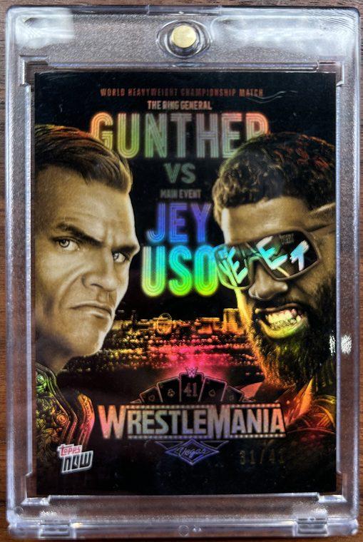 A Gunther versus Jey Uso Topps Now WrestleMania card in a magnetic one-touch holder