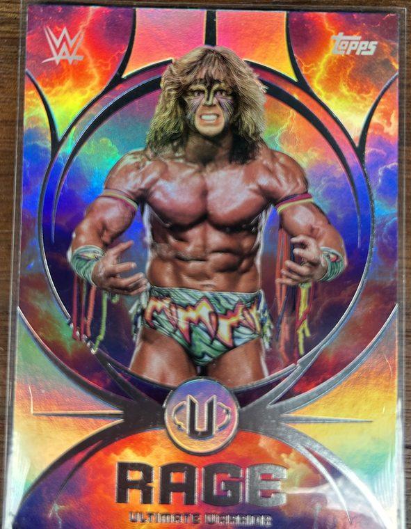 An Ultimate Warrior Rage insert card from Topps Universe in a penny sleeve